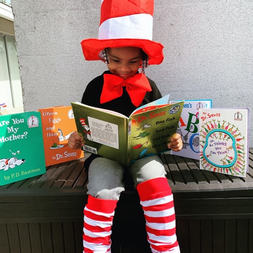  girl surrounded by dr. seuss books